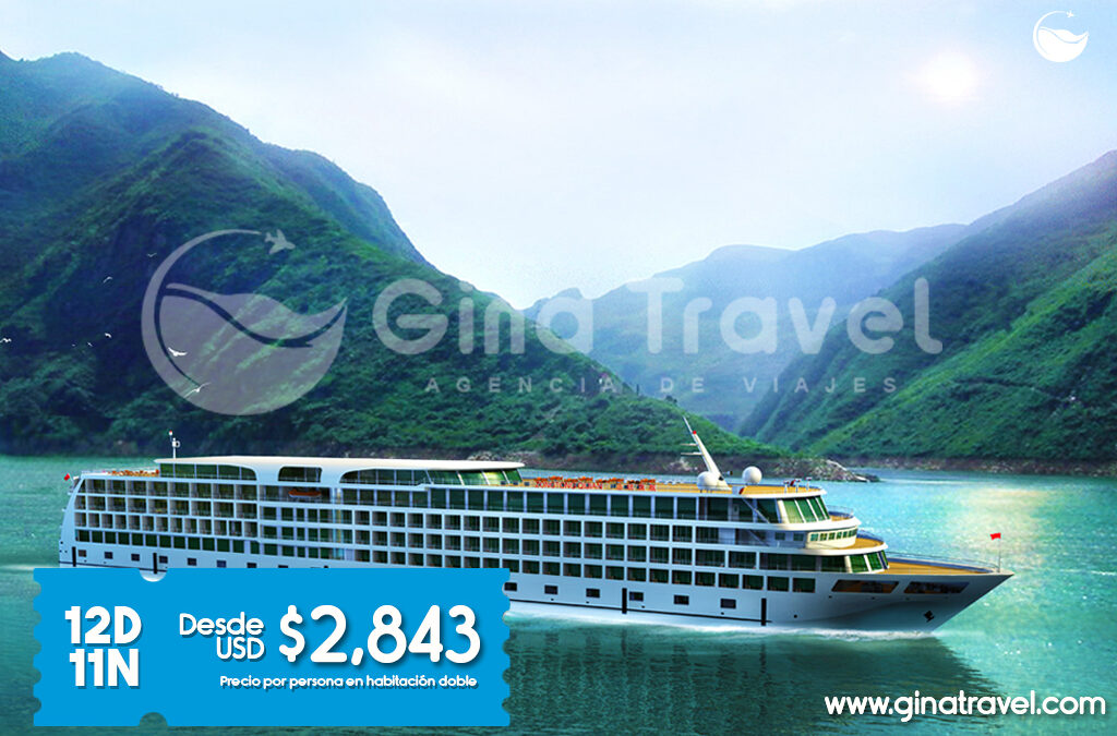 Crucero turístico navegando por el río Yangtsé en China, rodeado de paisajes montañosos y tradicionales pueblos chinos.